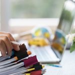 businessman-hands-holding-pen-working-stacks-paper-files-searching-information-r_4236-1032