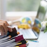businessman-hands-holding-pen-working-stacks-paper-files-searching-information-r_4236-1032